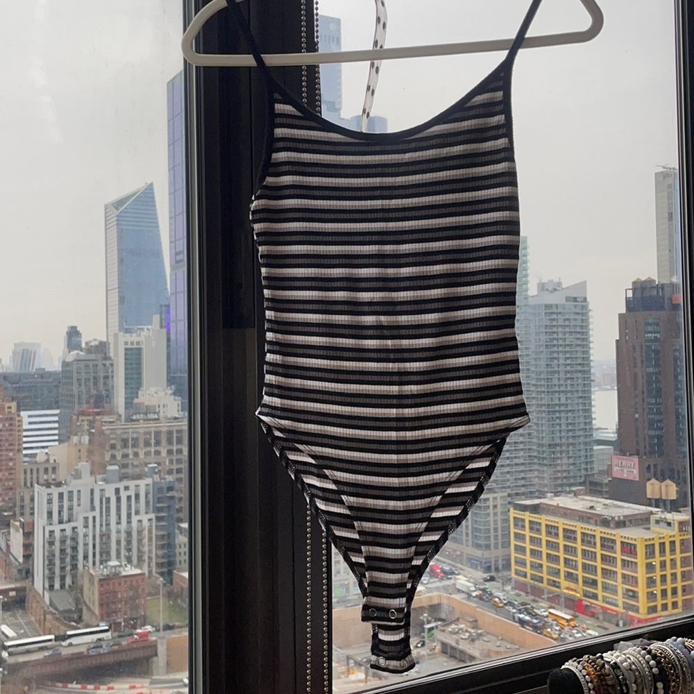 Striped black body suit.